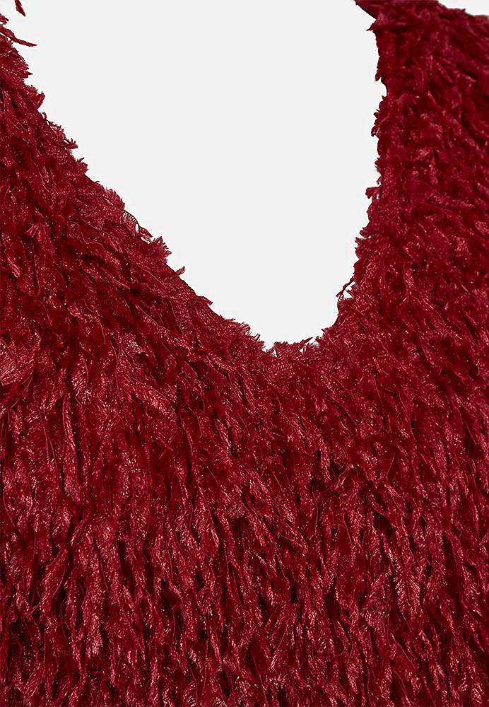 Festtop med fjerlignende materiale